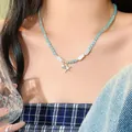 Detailed close-up of blue beaded necklace with fish elements and starfish pendant - Blue Beaded Starfish Fish Necklace (HN12166) / Silver-Blue