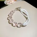 Close-up detail of asymmetric multi-layer pearl bracelet with faceted pink acrylic beads - 57# Bracelet / Pink-White
