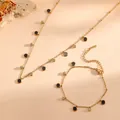 Close-up of gold stainless steel necklace and bracelet set with black disc pendants - Black Shell Disc Necklace Bracelet Set (L210+T808) / Gold