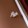 Detailed close-up of a silver octagram ear cuff featuring sparkling clear rhinestones - Star Style / Silver