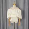 Elegant off-shoulder cream corset top with voluminous pleated ruffles and fitted waist - S / Apricot