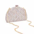 Detail of semi-circular acrylic evening clutch with marble texture and golden chain - Lotus Pink