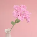 Handmade crochet lily flower in pink yarn with beaded stamens in a white vase - Rose Pink