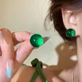 Close-up of vibrant green translucent ball stud earrings for women fashion jewelry - Silver Earring Post-Green