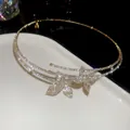 Macro detail of luxury sparkling rhinestone butterfly choker with exquisite pavé setting - Choker Necklace / Gold