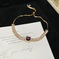 Elegant French vintage gold-tone bracelet featuring a central purple square zircon stone - Style 15 Bracelet / Gold Purple