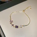 Elegant gold adjustable bracelet featuring purple zircon stones and floral charms - Style 16 Bracelet / Gold Purple