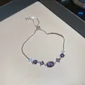 Elegant silver bracelet featuring purple zircon stones and adjustable chain pull - Style 17 Bracelet / Silver Purple