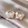 Macro view of sweet flower basket earrings with tiny pearls and sparkling crystals - Flower Basket Hoop Style / Silver