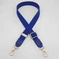 Close-up of dark blue woven bag strap with golden metal clasps and adjustable buckle - Klein Blue