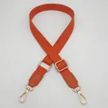 Detail of adjustable cotton shoulder strap with golden metal hooks and orange leather ends - Orange