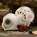 Cute white and black resin cat figurine in a lazy pose with a traditional folding fan - Free-spirited Cat (1188-55)