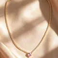 Gold tennis necklace featuring white cubic zirconia and a pink heart pendant on satin - Pink Heart - Gold