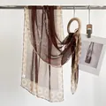 Brown and beige silk scarf with white calligraphy and geometric border patterns - Ink Wash Coffee