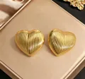 Vertical textured golden heart stud earrings displayed in a premium jewelry gift box - 10