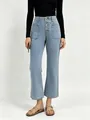 Detail view of high waist light blue denim jeans with four vintage button fly and pockets - S / Light Blue