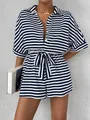 Detail of blue and white striped romper featuring a shirt collar and button-down front - Navy Blue