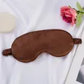 Dark brown faux silk sleep mask with elastic strap for comfort on white fabric background - Dark Brown