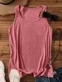 Flat lay of a summer ribbed tank top in mauve color with vacation style accessories - Rose Gold