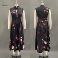 Detail of black sleeveless maxi dress featuring floral print and Mandarin collar design - S / Black