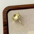 Irregular textured gold lava hair clip in modern minimalist style on jewelry tray - Gold Irregular Square Studs