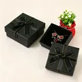 Elegant black square jewelry gift box with gold-trimmed ribbon and red flower necklace - 5x5x3cm (With Sponge) / Classic Black (Gold Edge)