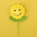 Handmade crochet sunflower with a cute smiley face and green leaves on a yellow background - Yellow-smiley Sunflower Branches