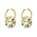 Close-up of gold hoop earrings with white enamel floral charms and green leaves - White