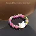 Detail of faceted tourmaline beaded ring with a white shell cat head charm - Faceted Tourmaline (Shell Cat)