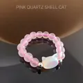 Close-up of beaded ring with rose quartz beads and shell cat head pendant charm - Rose Quartz (Shell Cat)