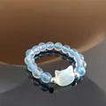 Handmade light blue beaded ring with white cat head charm and silver metal accents - Aquamarine (Shell Cat)