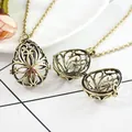 Vintage bronze hollow locket pendant necklace shown in open and closed positions - Antique Bronze Teardrop Four-Petal Flower Pendant