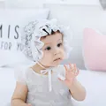 Detailed view of white lace baby bonnet with delicate floral patterns and ruffled edges - Double Layer Lace Hat