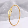 Elegant gold braided cable bracelet featuring a signature U-shaped horseshoe buckle - Gold (Magnetic Elastic)