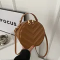 Brown circular crossbody bag with V-quilted faux leather and adjustable strap - Brown