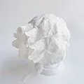 Close-up of intricate floral embroidery and scalloped lace on the baby bonnet - Embroidered Cotton Hat