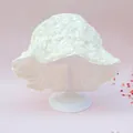 Lace baby sun hat in creamy white with delicate 3D daisy embroidery on stand - White Daisy Bucket Hat