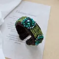 Detailed macro shot of handmade bohemian woven bracelet with green square stones - 6-Green Gem Seed Beads Crystal