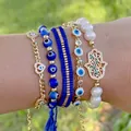 Five-piece evil eye bead bracelet set with Hamsa hand and heart charms on a female wrist - Welcome to customize