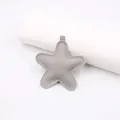 Close-up of grey star leather pendant with white stitching detail and silver ring - Star Accessories / Gray