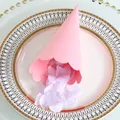 Close-up of pink confetti cone with wavy edges and purple petals on a decorative plate - Rose Red
