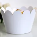 Elegant white laser-cut cupcake wrappers with scalloped edges for dessert decoration - White