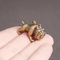 Antique brass bulldog miniature pendant with vintage finish shown in hand for size - Small Bully Dog
