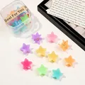 Close-up of star-shaped candy-colored hair claws in a transparent storage box - Star / Jelly Color