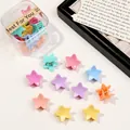 Macro view of colorful star-shaped hair clips in macaron colors and clear packaging box - Star / Spring Colors