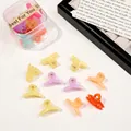 Close-up of colorful mini hair clips set with a clear square storage box on white desk - Cross / Jelly Color