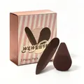 Detailed view of two dark brown makeup sponges in a pink striped 2-piece set box - Magic Pen And Egg Detail Puff Combo