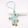 Detail of mint green leather bear charm with contrast stitching and brown accents - Bear Style / Blue