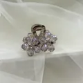 Detailed close-up of purple crystal flower hair claw clip with rhinestones - Small Floral Purple