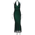 Detail view of deep green halter neck mesh dress with ruching and fish-tail hemline - S / Green
